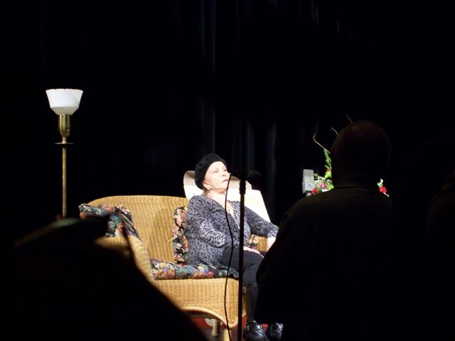 Maria Elena Holly talking at a symposium at the school auditorium.jpg